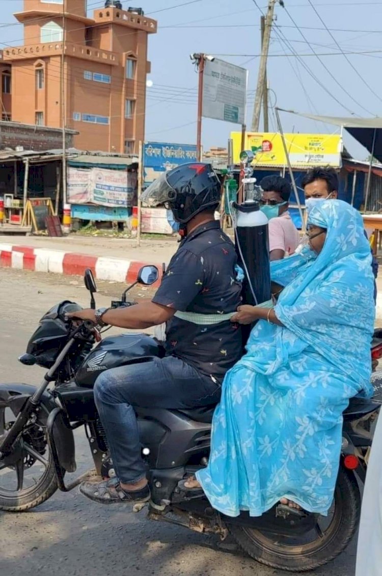 পিঠে অক্সিজেন বেঁধে স্ত্রীকে নিয়ে গেলেন হাসপাতালে